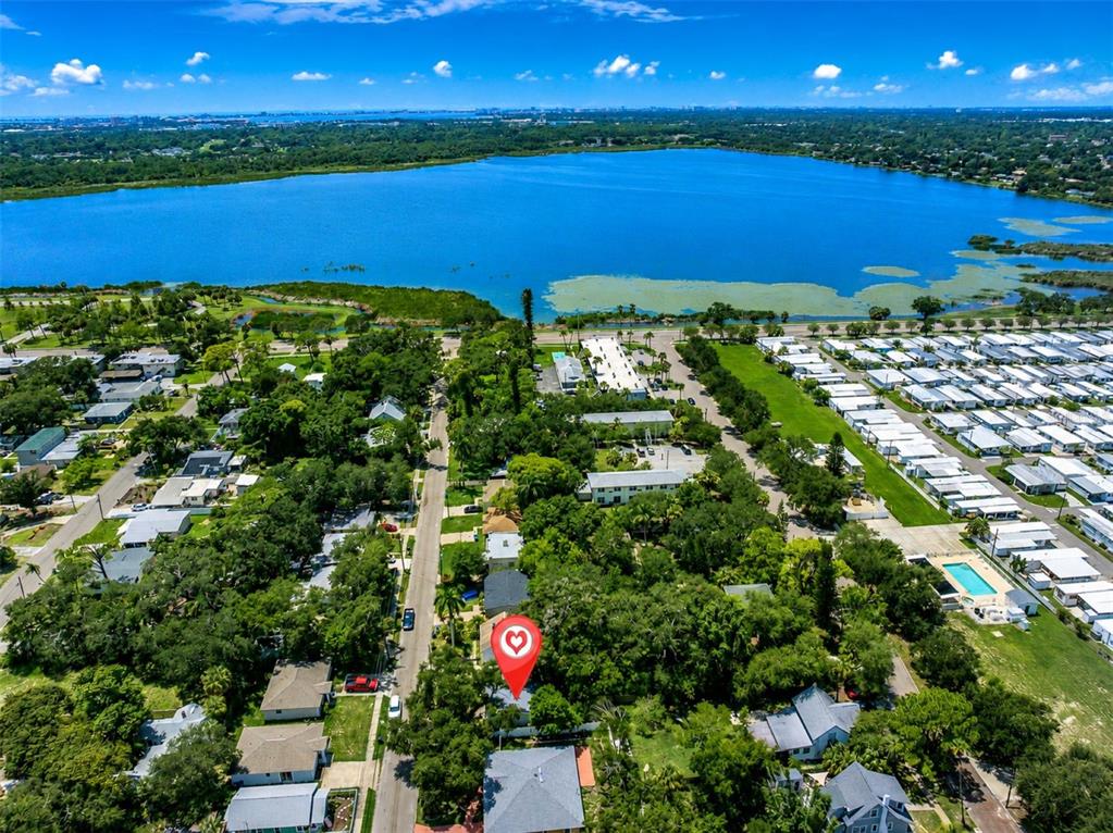 This is an aerial view of a residential neighborhood situated next to a large lake — 791 35TH AVENUE S, ST PETERSBURG, FL