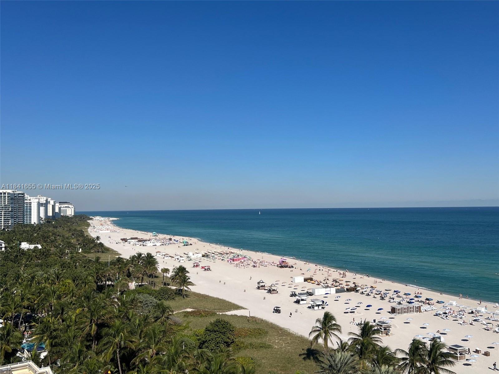An aerial view shows a sandy beach with palm trees and high-rise buildings — 100 Lincoln Rd # 1419, Miami Beach FL 33139, MIAMI BEACH, FL