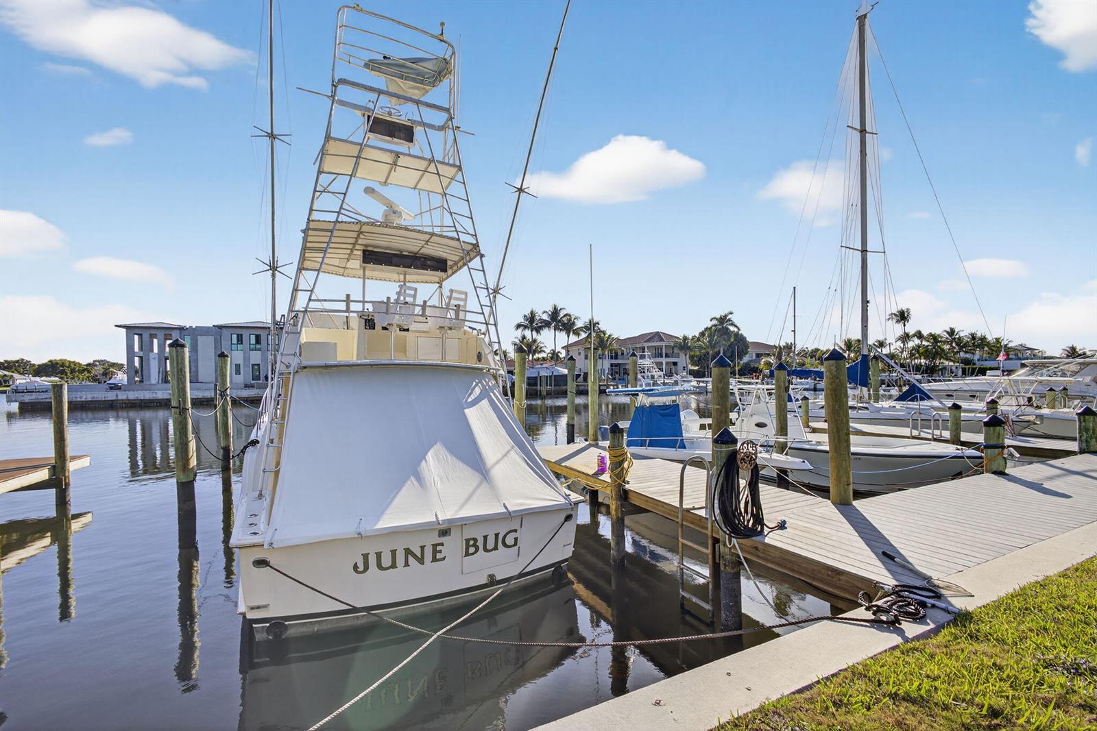 A white sport fishing boat named June Bug is docked at a marina — 752 Lagoon Drive, North Palm Beach FL 33408, NORTH PALM BEACH, FL