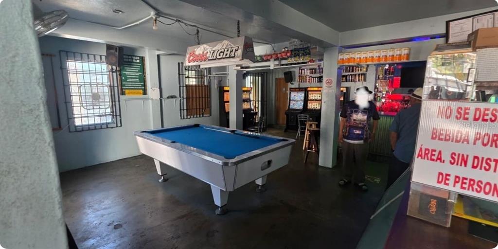 A pool table sits in the center of a bar area with gaming machines — Carr PR-123 Km 78.9 BO HATO VIEJO, ARECIBO, PR