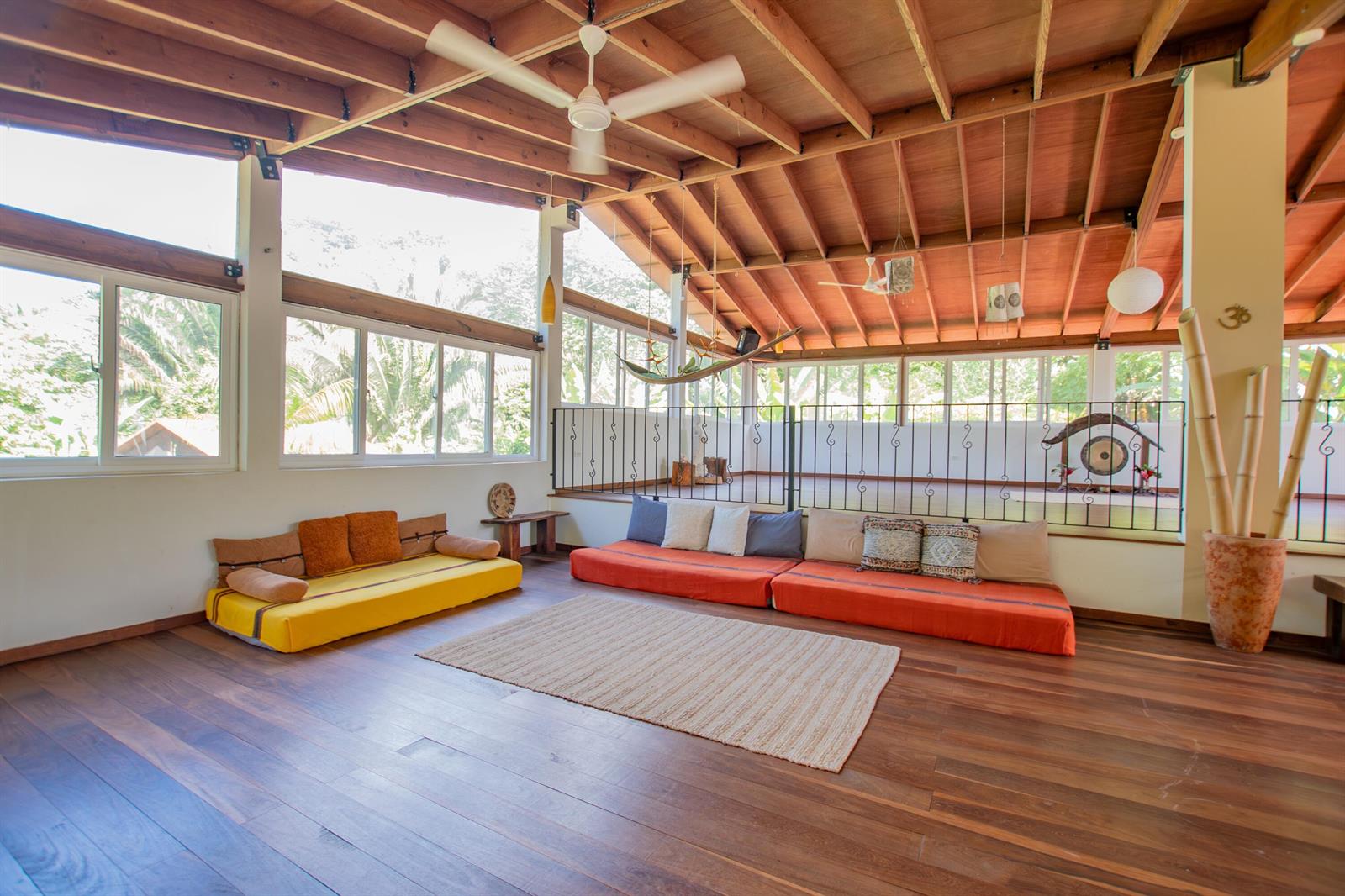 A spacious room with a vaulted wood ceiling, hardwood floors, and low-profile floor seating — 21 Hummingbird Way, 00000, FL