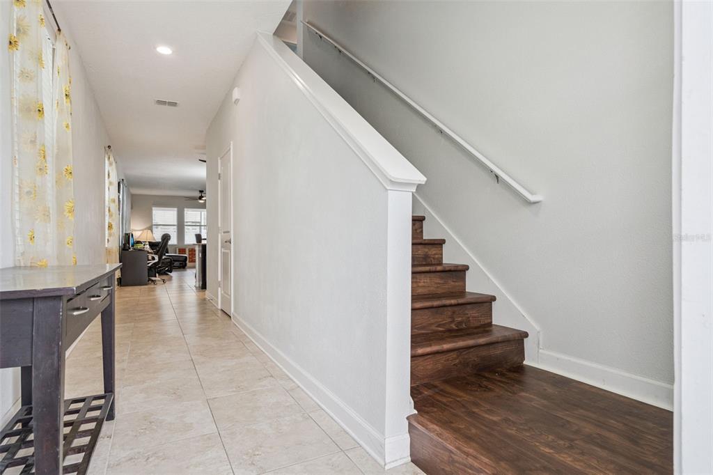 A single-story house with light blue siding, a stone-accented porch, and a paved driveway — 4633 FAIRY TALE CIRCLE, KISSIMMEE, FL