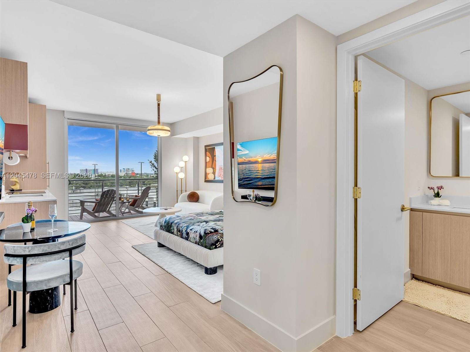 A studio apartment features a dining area, a bed, a balcony, and an attached bathroom — 90 NE 32nd st # 724, Miami FL 33137, MIAMI, FL