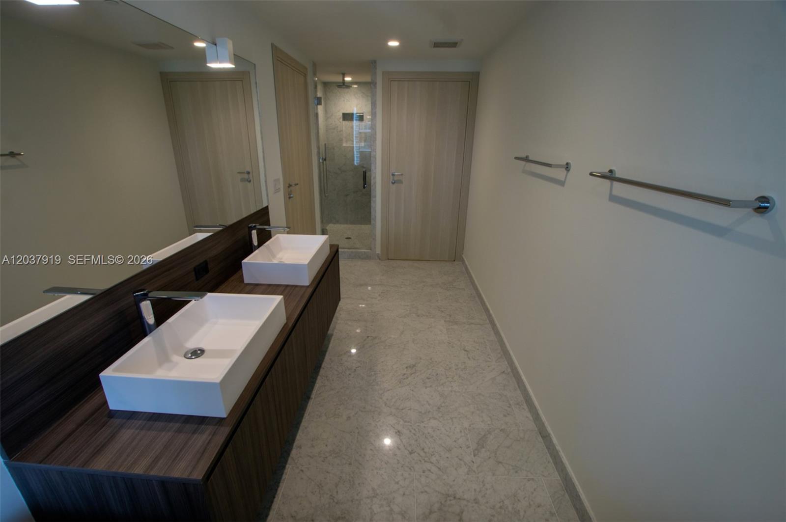 A modern bathroom features a double vanity with vessel sinks and a walk-in shower — 1000 Brickell Plaza # 2809, Miami FL 33131, MIAMI, FL