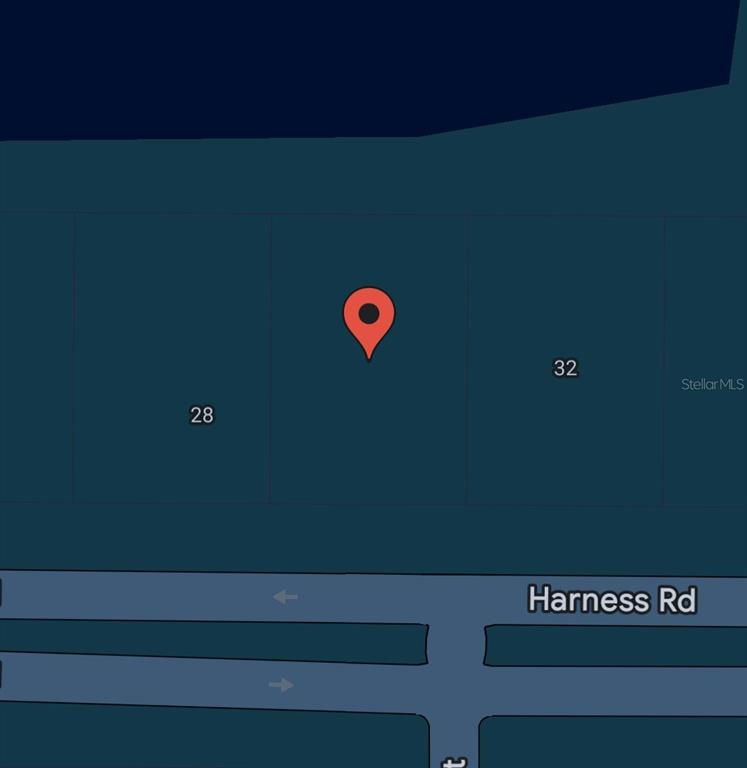 This map shows a red location pin on a vacant lot between plots 28 and 32 — 30 HARNESS ROAD, PLACIDA, FL