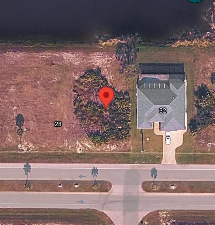 This aerial map shows a vacant lot marked with a pin next to a house — 30 HARNESS ROAD, PLACIDA, FL