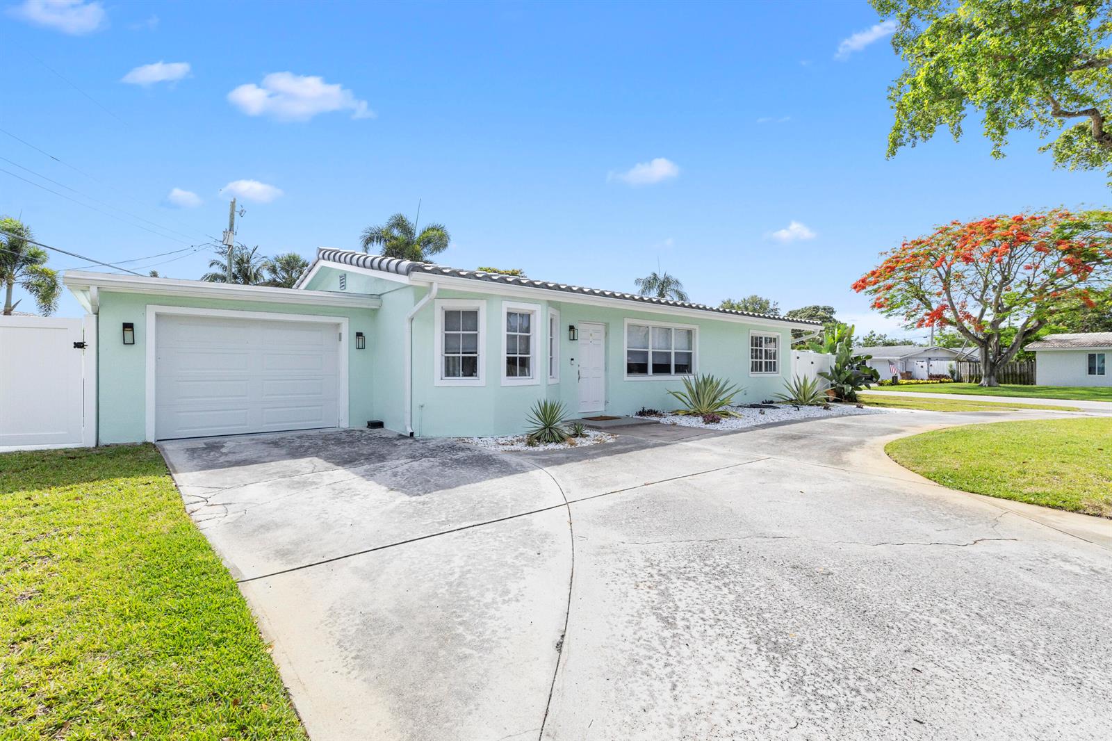 A light green single-story house with a tiled roof, garage, and front yard — 612 SE 10th Avenue, Deerfield Beach FL 33441, DEERFIELD BEACH, FL