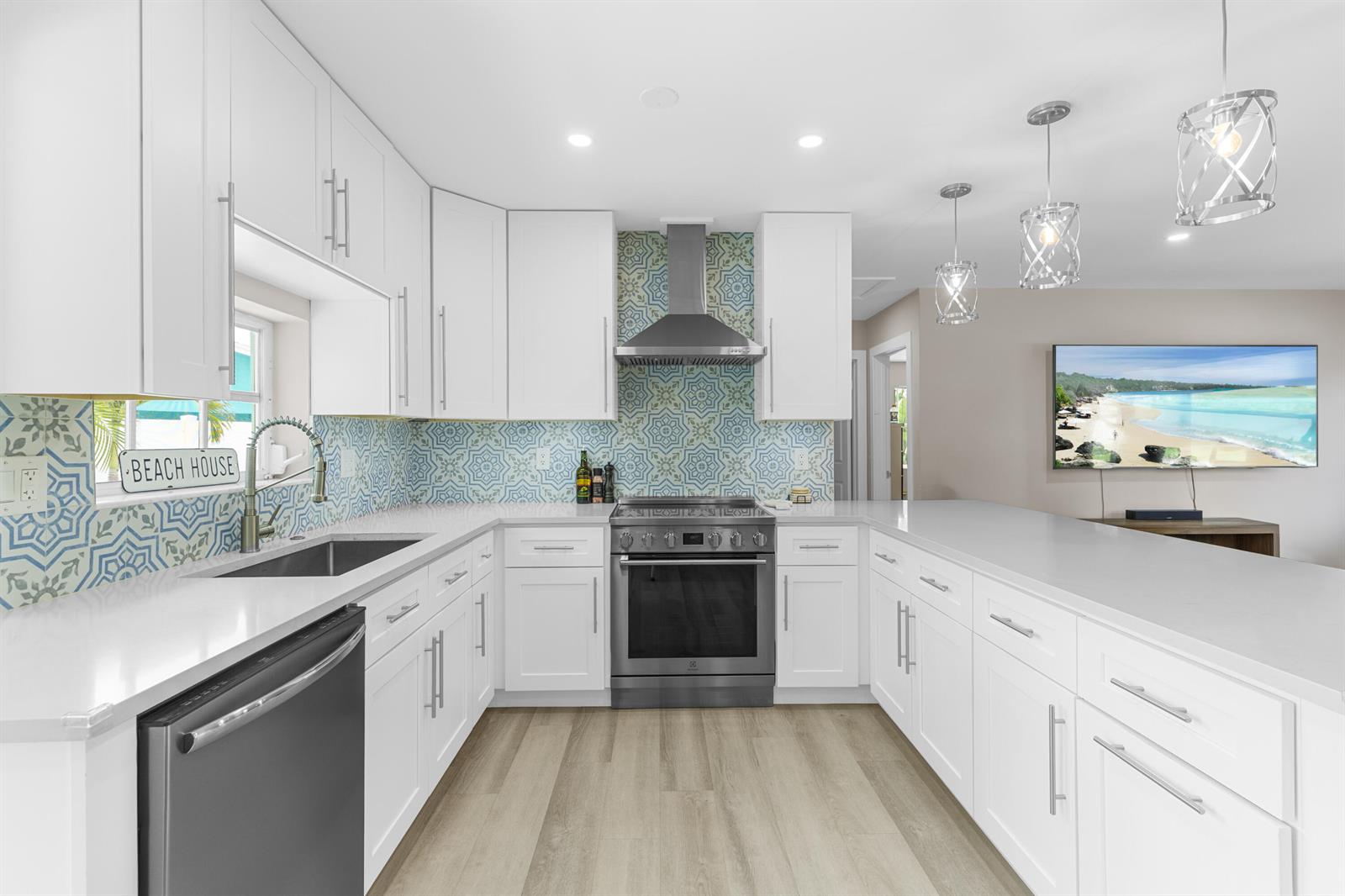 A light green single-story house features a white garage door and a front lawn — 612 SE 10th Avenue, Deerfield Beach FL 33441, DEERFIELD BEACH, FL