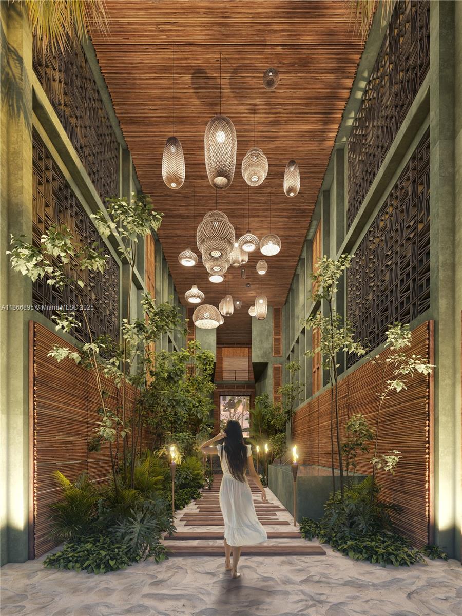This rendering shows a woman walking through a tropical-style hallway with sand flooring and lanterns — - 22 TANKAH # 303, 0 0, 0
