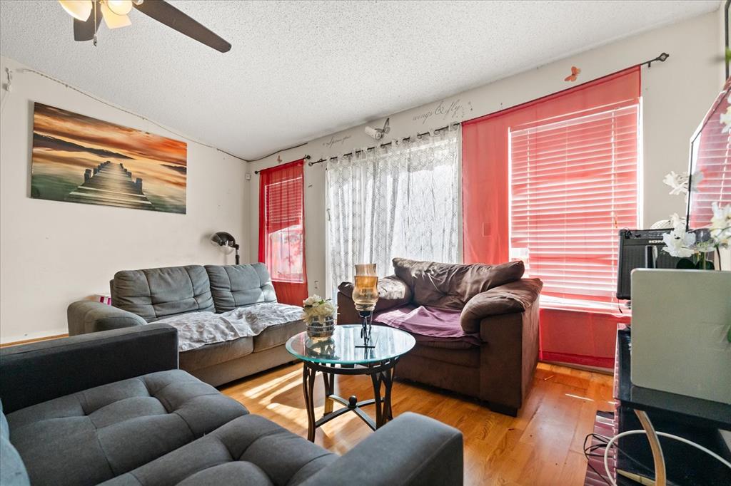 A living room with gray and brown sofas, a glass coffee table, and red blinds — 1321 DUNBARTON COURT, KISSIMMEE, FL