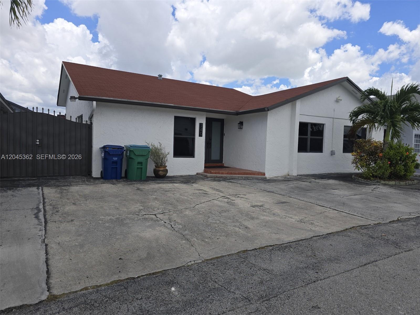 A white single-story house with a red roof and a concrete driveway — 740 SW 99th Ct Cir # 0, Miami FL 33174, MIAMI, FL