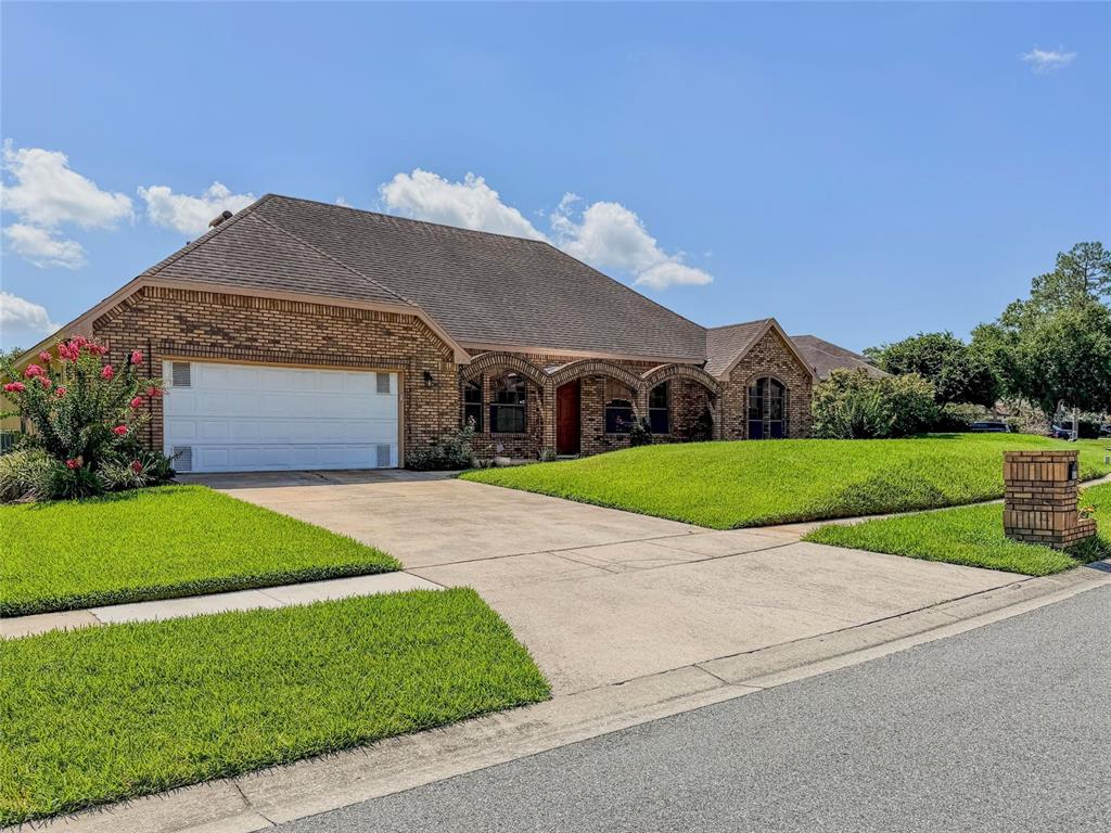 A single-story brick house with a two-car garage and an arched entryway — 9731 SIBLEY CIRCLE, ORLANDO, FL