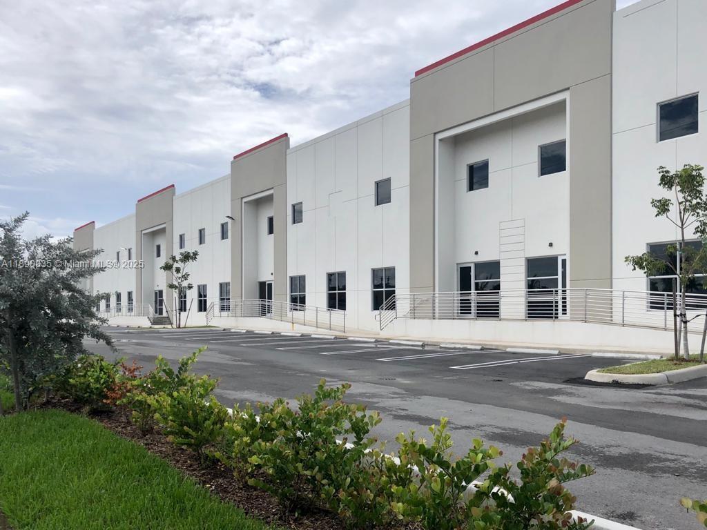 A modern, multi-unit industrial warehouse building with white exterior walls and a paved parking lot — 13202 NW 107th Ave # 5, Hialeah Gardens FL 33018, HIALEAH GARDENS, FL