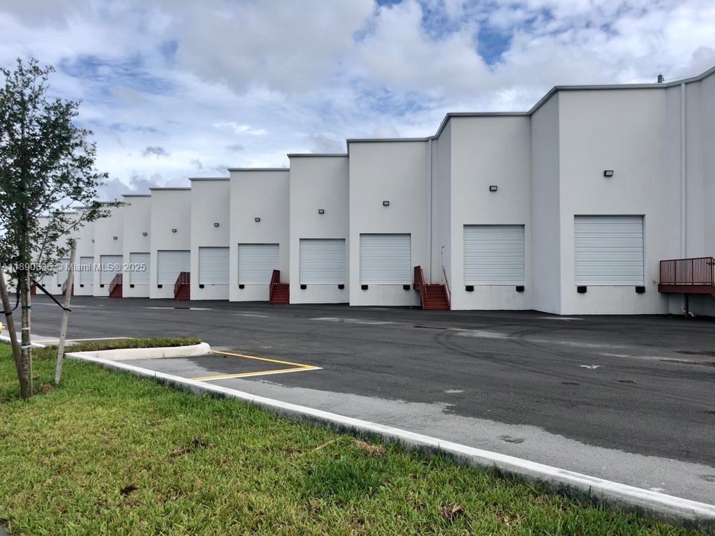 A row of industrial warehouse bays with white walls and roll-up doors — 13202 NW 107th Ave # 5, Hialeah Gardens FL 33018, HIALEAH GARDENS, FL