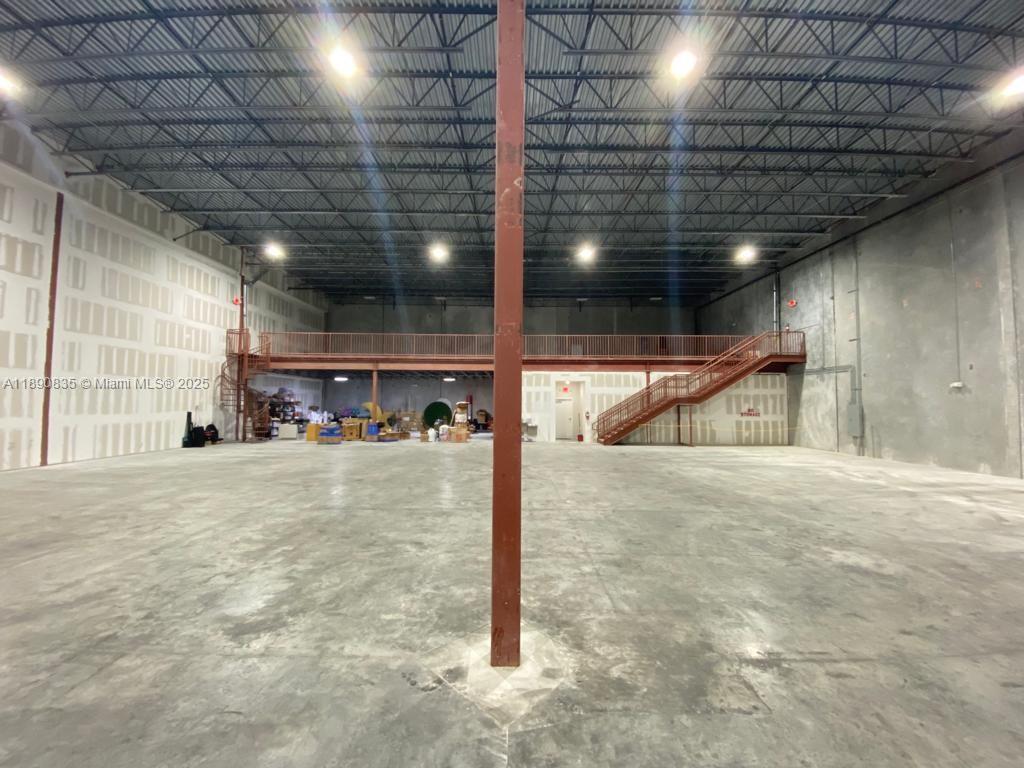 A large industrial warehouse space features a concrete floor, metal ceiling, and a mezzanine level — 13202 NW 107th Ave # 5, Hialeah Gardens FL 33018, HIALEAH GARDENS, FL