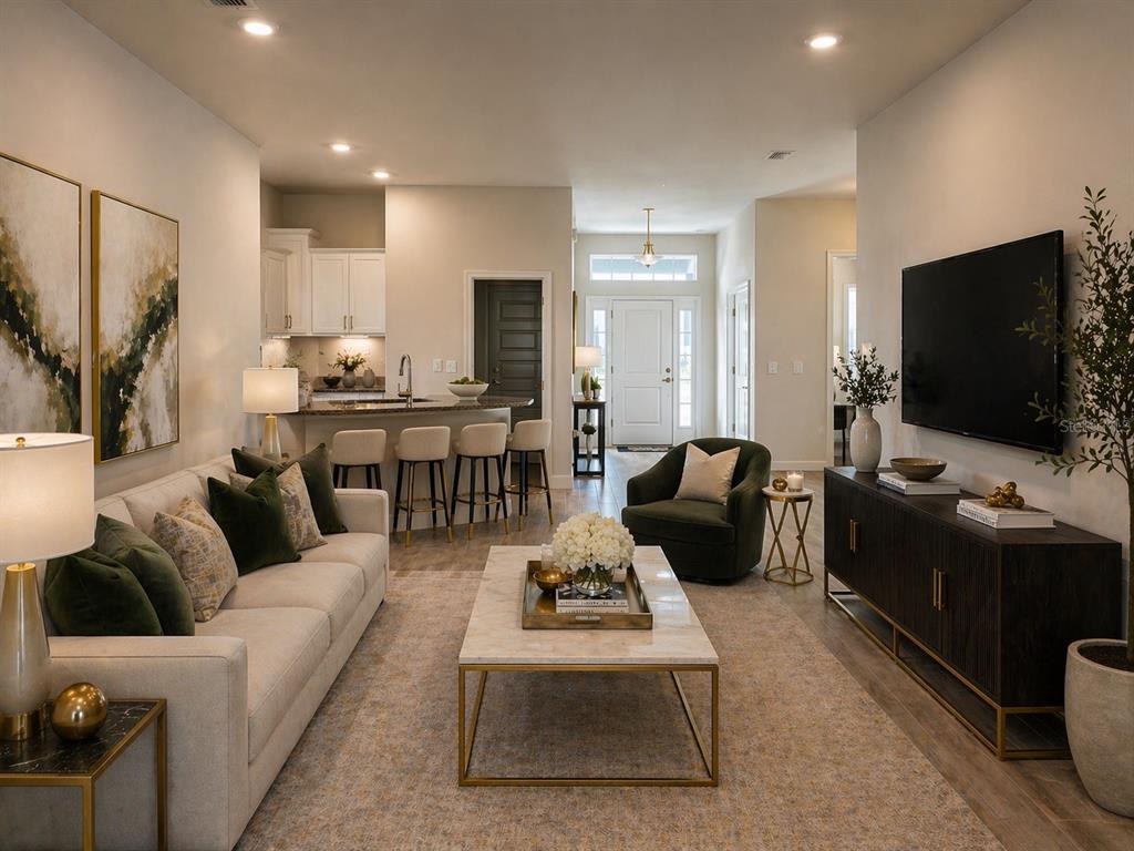 A living room features a beige sofa, a marble coffee table, and a wall-mounted television — 12909 OGDEN GLADE RD STREET, DADE CITY, FL