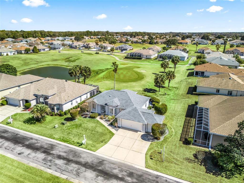 An aerial view shows a suburban house with a gray roof situated on a golf course — 2449 NW 59TH TERRACE, OCALA, FL