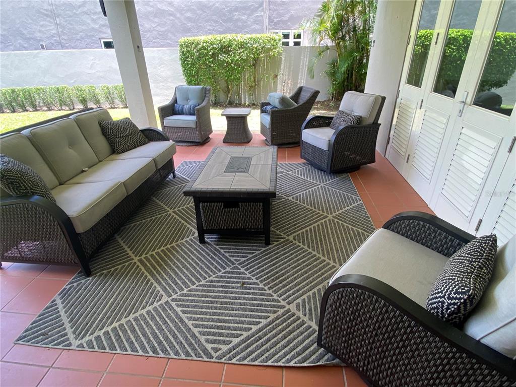 A covered patio features wicker furniture, a patterned rug, and a tiled floor — 268 DORADO BEACH EAST, DORADO, PR