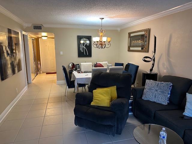 A living and dining area with tile floors, a dark recliner, and a chandelier — 7600 NW 5th Place # 106, Margate FL 33063, MARGATE, FL
