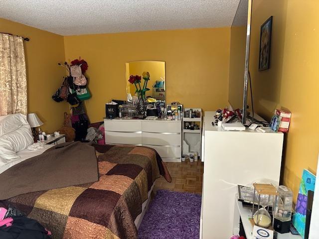 A bedroom features yellow walls, a bed with a brown quilt, and a white dresser — 7600 NW 5th Place # 106, Margate FL 33063, MARGATE, FL