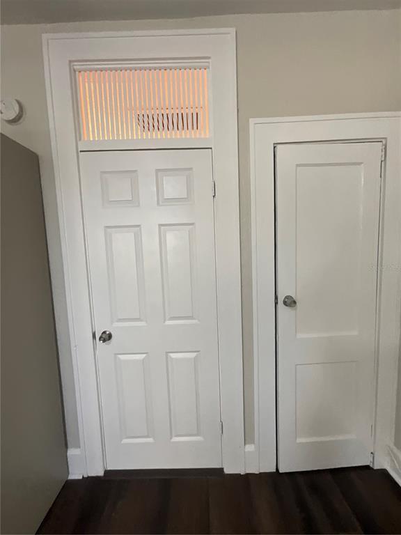 Two white interior doors, one with a transom window above, set against a neutral wall — 2608 CENTRAL AVENUE UNIT 4, ST PETERSBURG, FL
