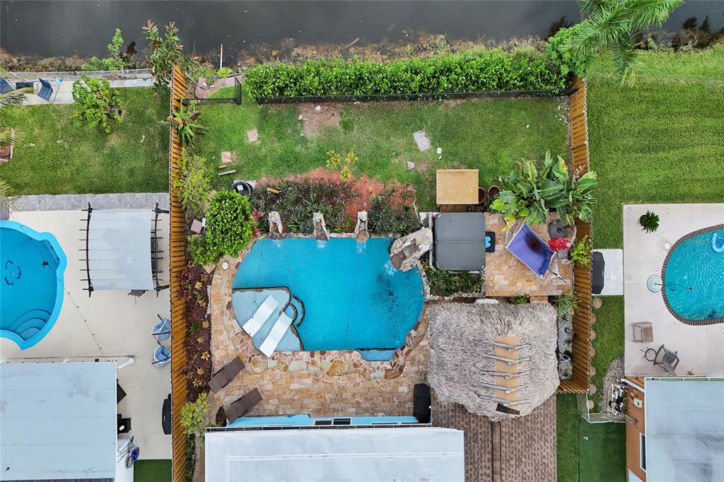 An aerial view shows a backyard with a swimming pool, hot tub, and tiki hut — 12341 NW 29TH MANOR, SUNRISE, FL