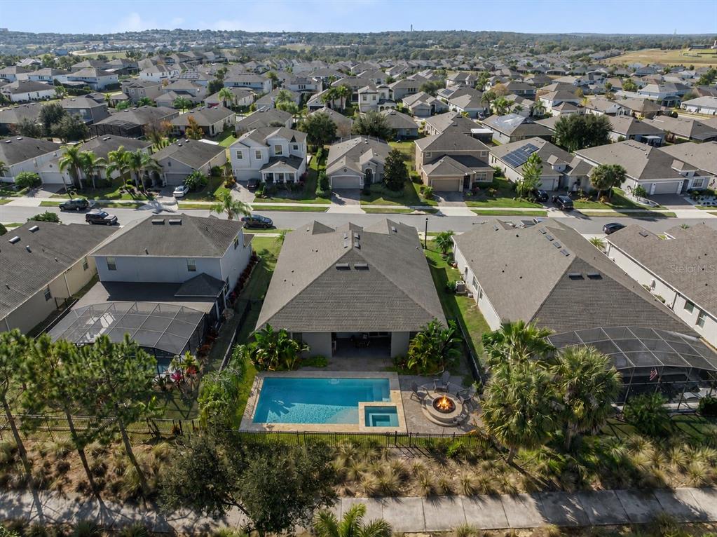 An aerial view shows a suburban neighborhood with single-family homes and a marked property — 1025 SADIE RIDGE ROAD, CLERMONT, FL