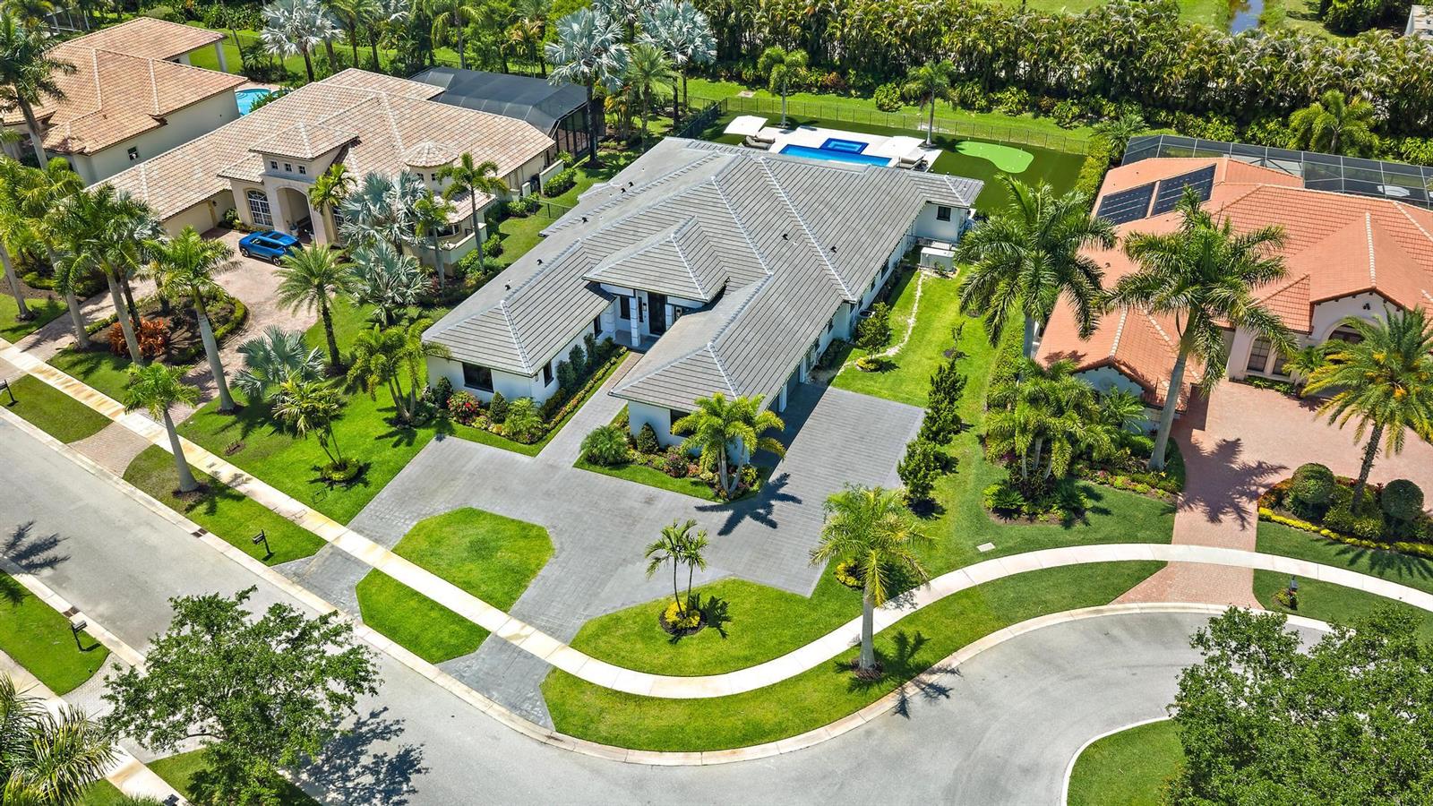 An aerial view shows a suburban house with a gray roof and a backyard pool — 6087 Wildcat Run, West Palm Beach FL 33412, WEST PALM BEACH, FL