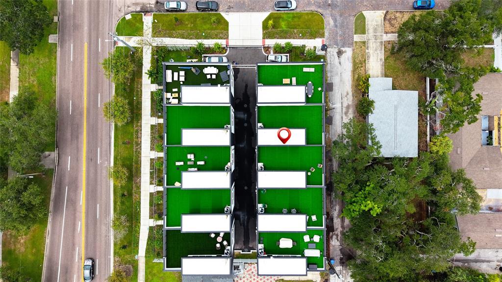 An aerial view shows a modern townhouse complex with rooftop terraces and a central driveway — 2114 4TH STREET S UNIT 7, ST PETERSBURG, FL