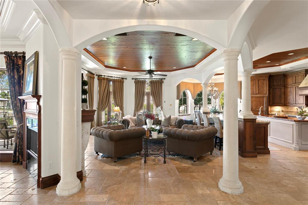 A living room with a coffered wood ceiling, stone columns, and tile flooring — 25 W SPANISH MAIN STREET, TAMPA, FL