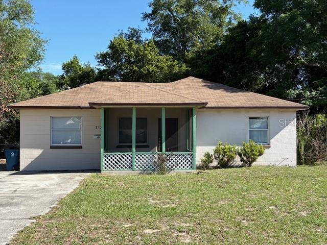 A single-story house with a brown shingled roof and a front screened-in porch — 713 EUCLID AVENUE, LAKE WALES, FL