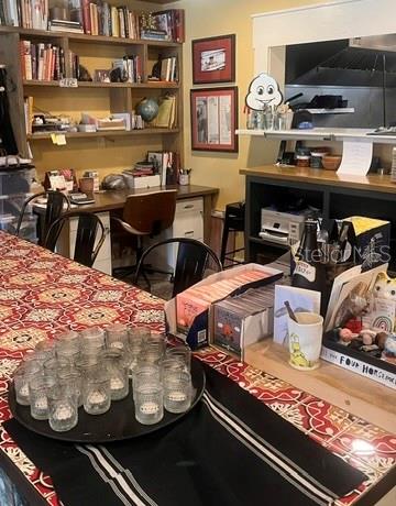A home office area features built-in bookshelves, a desk, and a kitchen counter with seating — 1518 S DIXIE FREEWAY, NEW SMYRNA BEACH, FL