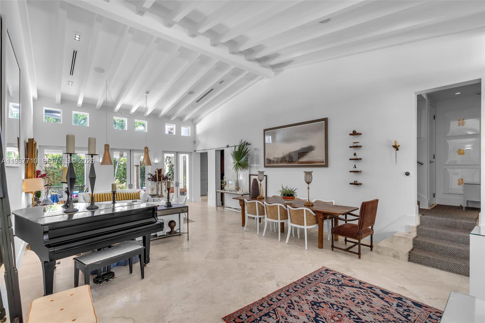 The spacious room features a living room and dining room with vaulted ceilings and high ceilings. — 140 Hampton Ln, Key Biscayne FL 33149, KEY BISCAYNE, FL