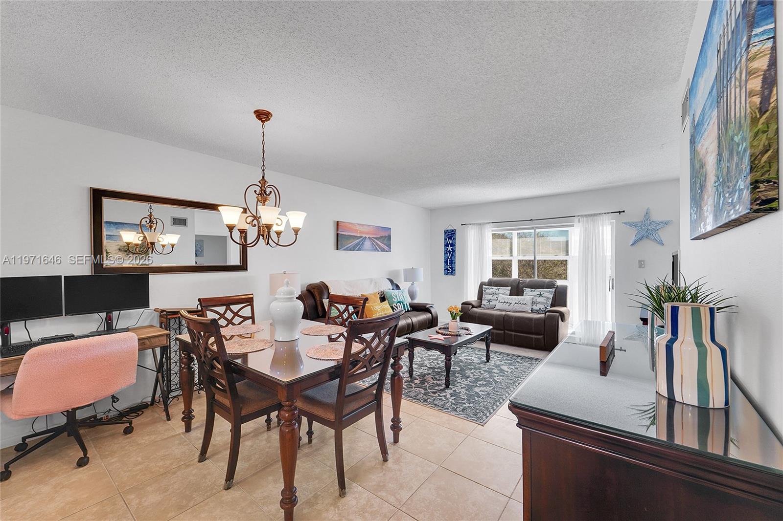 A living and dining area features tile floors, a wooden table, and brown leather furniture — 650 NW 80th Ter # 206, Margate FL 33063, MARGATE, FL