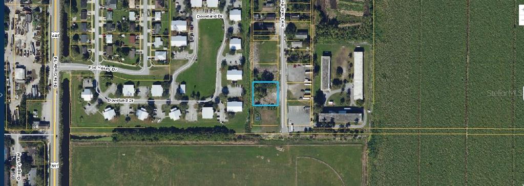 This aerial map shows a vacant rectangular lot highlighted in blue along a residential street — 875 JOE LOUIS AVENUE, PAHOKEE, FL