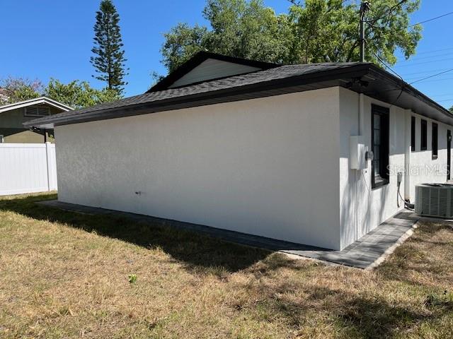 The exterior of a white stucco house features a dark roof and a window — 1256 S BUMBY AVENUE, ORLANDO, FL