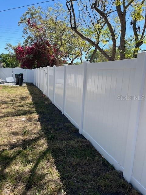 A white vinyl privacy fence runs along the edge of a grassy yard — 1256 S BUMBY AVENUE, ORLANDO, FL