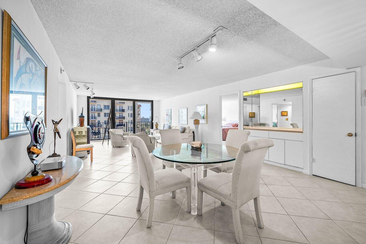 A dining area with a glass table and chairs opens into a bright living room — 3460 S Ocean Boulevard # 6150, Palm Beach FL 33480, PALM BEACH, FL