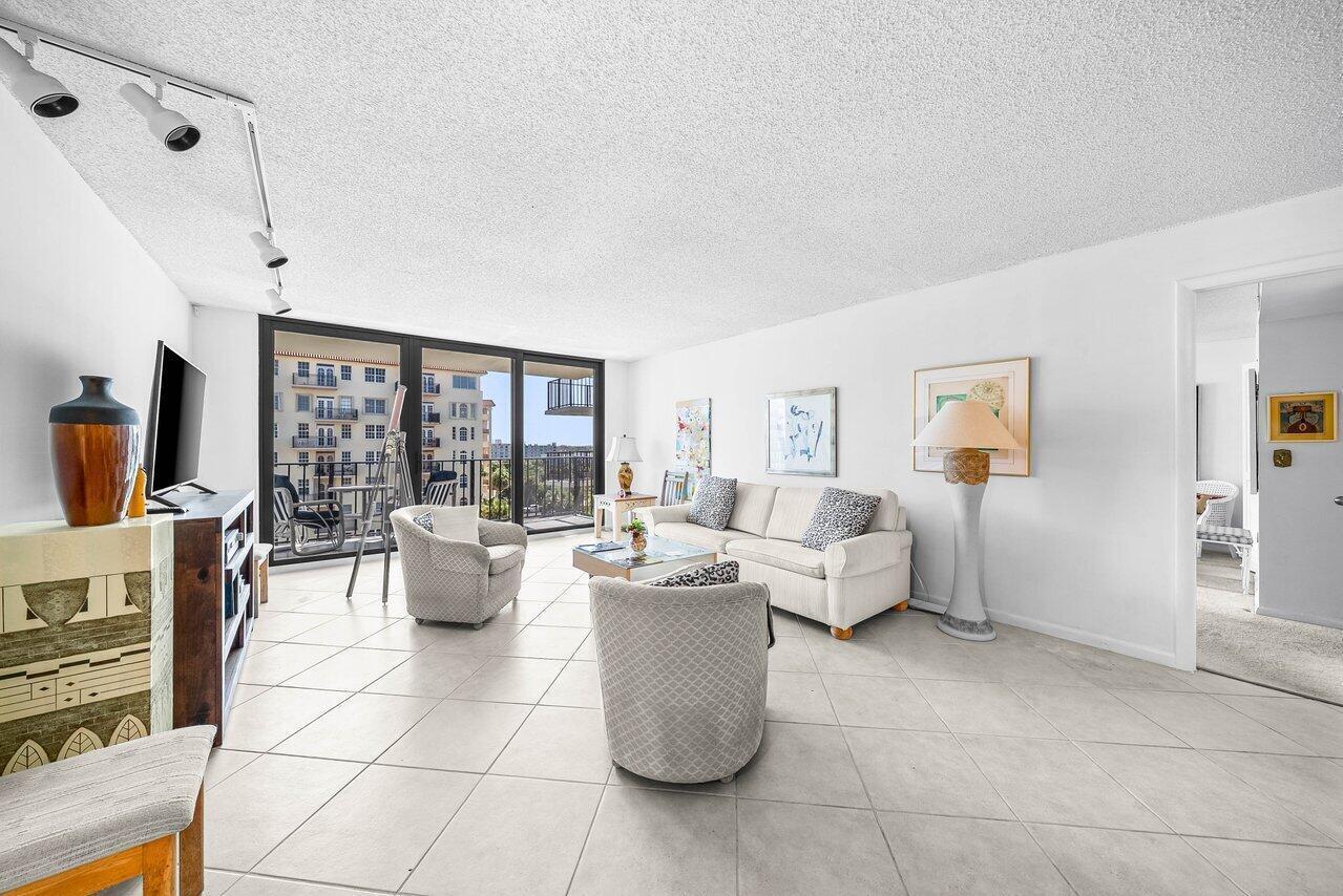 A living room features tile flooring, a beige sofa, two armchairs, and a balcony view — 3460 S Ocean Boulevard # 6150, Palm Beach FL 33480, PALM BEACH, FL
