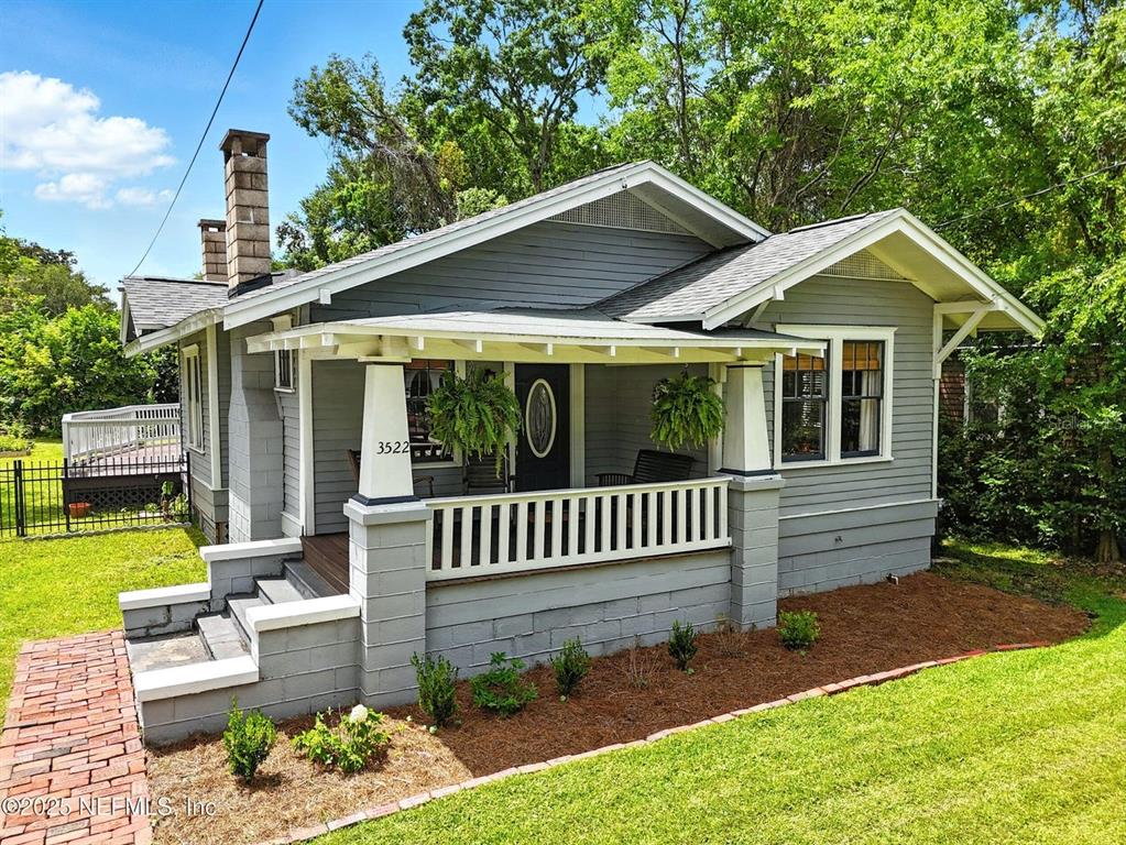 A gray bungalow features a front porch with white columns and a brick walkway — 3522 RANDALL STREET, JACKSONVILLE, FL