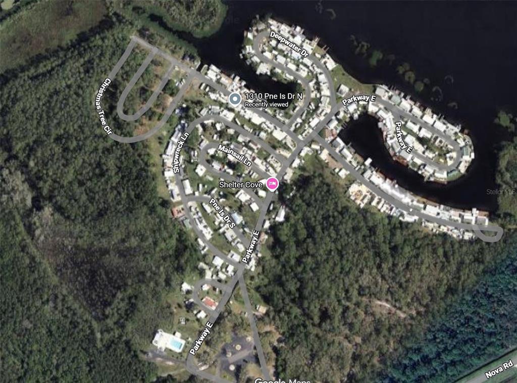 This is a satellite map view of a residential neighborhood with waterfront homes and streets — 1310 PINE ISLAND DRIVE N, ST CLOUD, FL