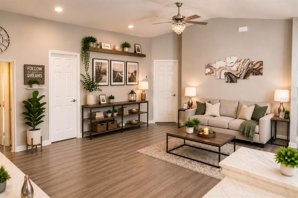 A living room features a beige sofa, a wood coffee table, and a long console table — 8016 DIAMOND CREEK LANE, LAKELAND, FL