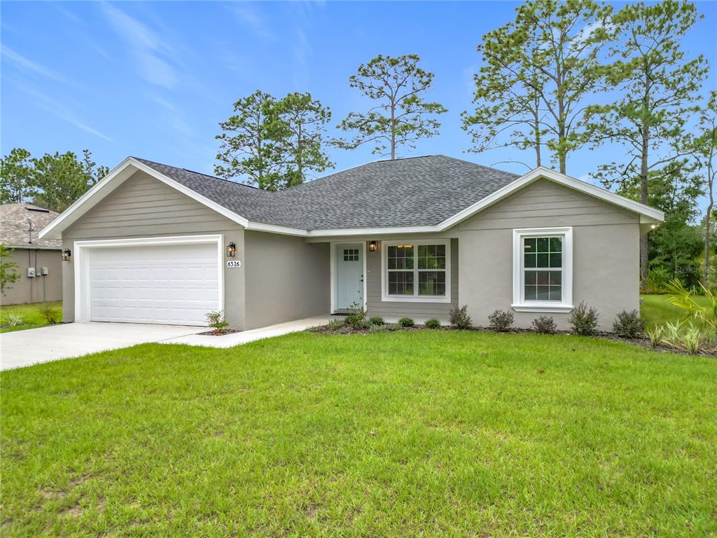A single-story house with a gray exterior, white trim, and a two-car garage — 6526 N EARLSHIRE TERRACE, CITRUS SPRINGS, FL