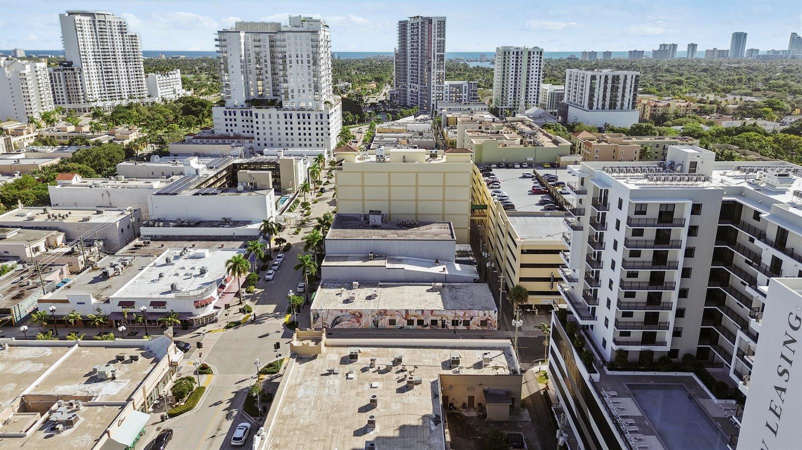 An aerial view shows a dense urban neighborhood with mid-rise apartment buildings and parking structures — 1940 Harrison Street, Hollywood FL 33020, HOLLYWOOD, FL