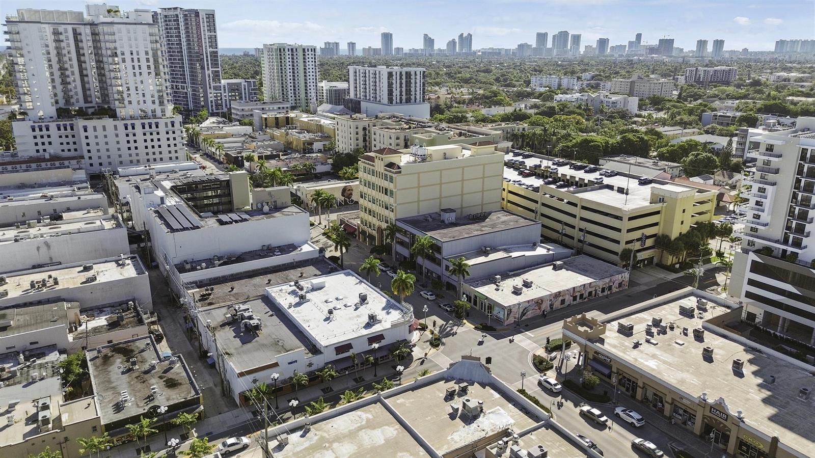An aerial view shows a city street intersection surrounded by low-rise commercial buildings and parking — 1940 Harrison Street, Hollywood FL 33020, HOLLYWOOD, FL