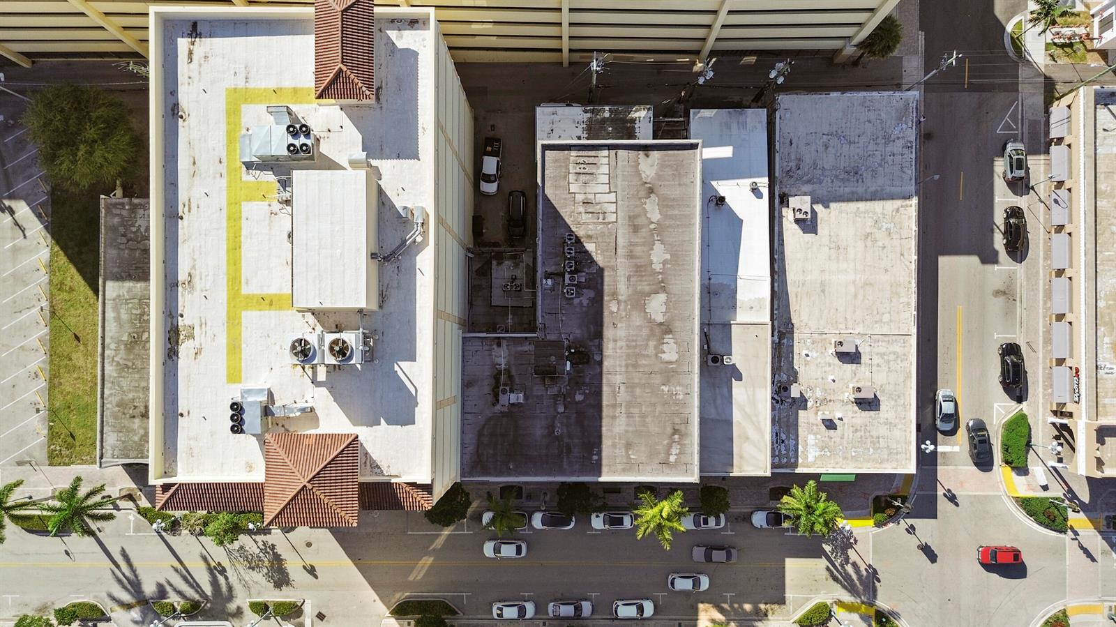 An aerial view shows the flat roofs of several commercial buildings and adjacent street parking — 1940 Harrison Street, Hollywood FL 33020, HOLLYWOOD, FL