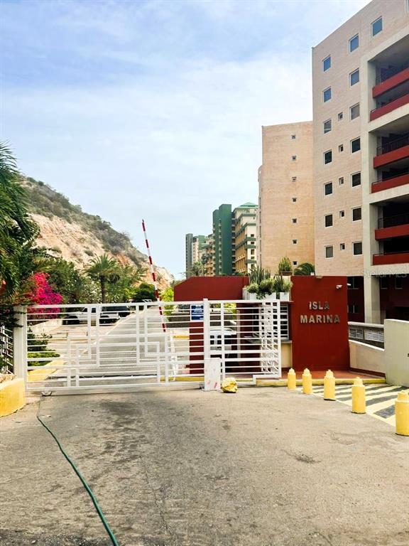 The exterior of the Isla Marina residential complex features a gated entrance and tall buildings — urb. Isla Marina AVENIDA LA COSTA (ANZOÁTEGUI, VENEZUELA) UNIT 10, LECHERIA, OC