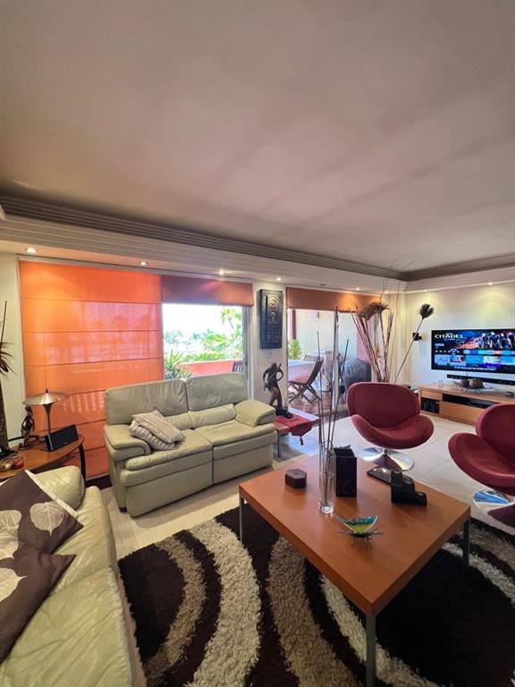 A living room with light-colored leather sofas, a wooden coffee table, and a balcony view — urb. Isla Marina AVENIDA LA COSTA (ANZOÁTEGUI, VENEZUELA) UNIT 10, LECHERIA, OC