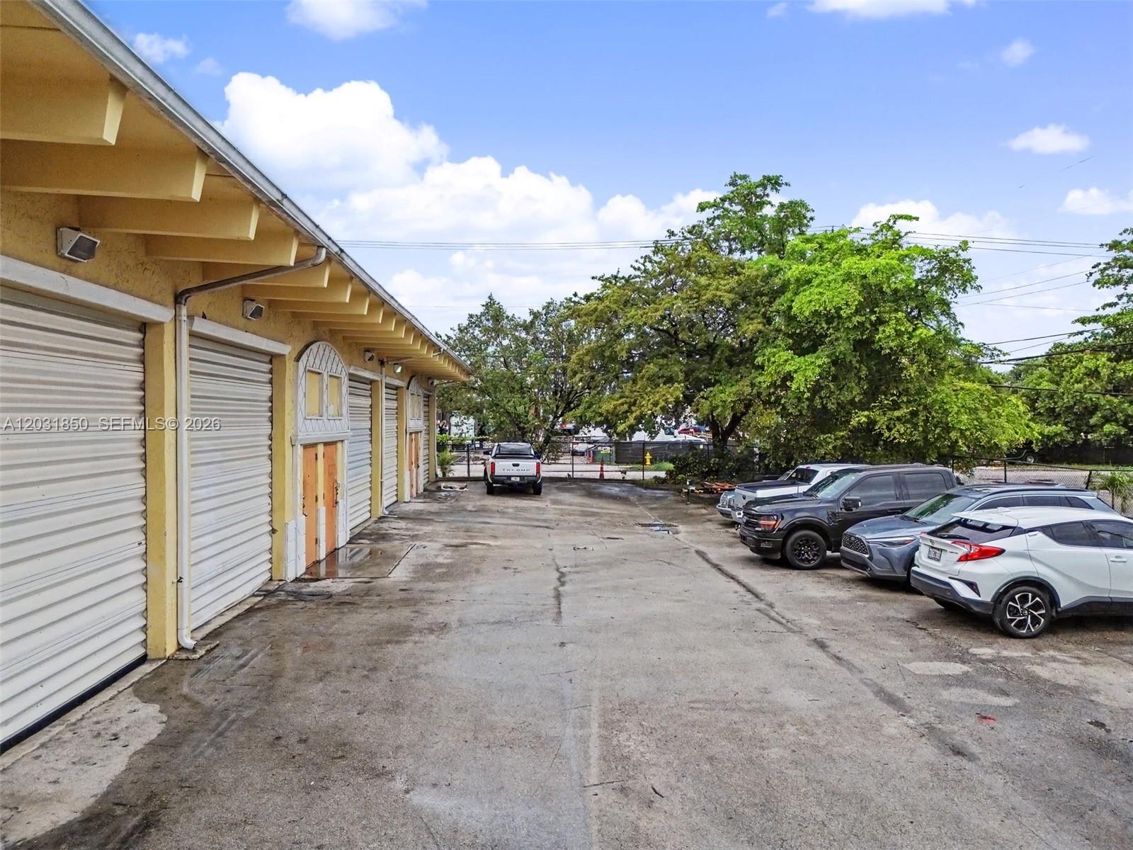 An exterior view shows a yellow industrial building with roll-up doors and a parking lot — 2225 SW 57th Ave # 2, West Park FL 33023, WEST PARK, FL