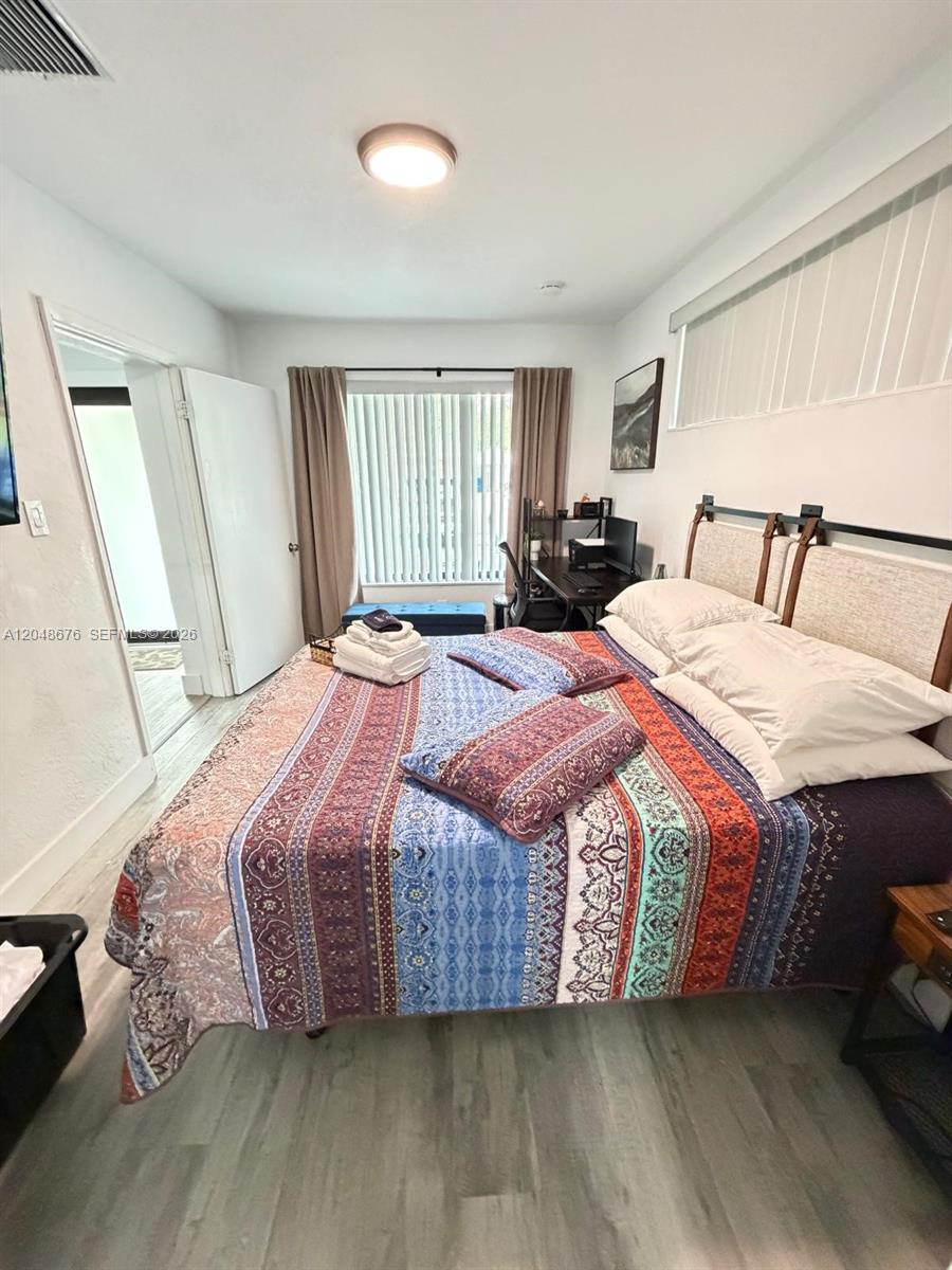 A backyard features a kidney-shaped swimming pool with a brick border and a concrete patio — 3360 NE 12th Ter, Pompano Beach FL 33064, POMPANO BEACH, FL
